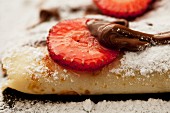 Crepes with chocolate sauce and strawberries (close up)