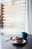 Slice of chocolate cake with pomegranate seeds and marshmallows (Christmas)