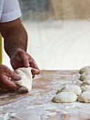 A chef kneading dough