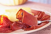 A supper plate with smoked ham, salami and cheese