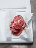 Freshly sliced veal knuckles (Ossobuco) on a piece of paper