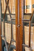 Collection of antiquarian books in glass-fronted cabinet
