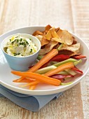 A goat's cream cheese and chive dip, raw vegetables and adjustable crisps