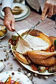 Roast turkey with a herb and pistachio stuffing being carved