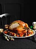 Carved roast turkey with a herb and pistachio filling and side dishes