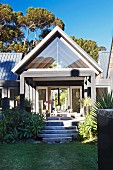 Modern house with steps leading to roofed terrace