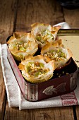 Mini leek and almond puff pastry tartlets in a tin