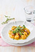 Carrot gnocchi with orange sauce and rocket
