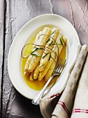 Cooked white asparagus with melted butter
