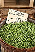 A basket of shelled peas with a price label