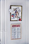 Framed artwork by Eric Larsen with postcards stuck in frame and menu from a famous Parisian restaurant