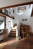 Foyer with open staircase in renovated country house