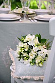 White bridal bouquet on cushion