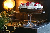 A festive chocolate cake with cream and glace cherries