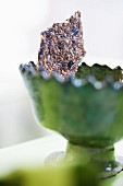 Sesame seed crispbread in a green bowl