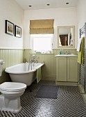 Traditional, country-house-style bathroom with pale green wainscoting and mosaic-tiled floor with small, chequered pattern