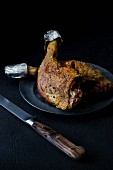 Slow-roasted duck legs on a pewter plate