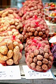 Fresh walnuts and potatoes on a market stand