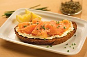 A slice of wholemeal bread topped with cream cheese and smoked salmon