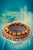Chocolate tart with popcorn on a cake stand
