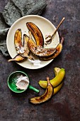 Green bananas fried in their skins with tahini and cocoa butter sprinkled with coconut flakes