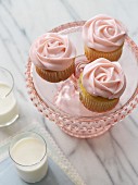 Rose cupcakes and two glasses of milk