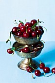 Fresh cherries in old silver dishes
