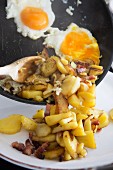 Fried potatoes with bacon and fried eggs