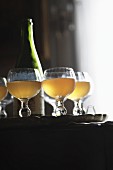 Glasses of cider and a bottle on a tray