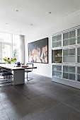 Modern dining area with classic chairs in open-plan kitchen