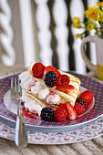 A pancake filled with vanilla cream and mixed berries