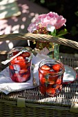 Glasses of berry compote on top of a picnic basket
