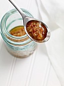 Chinese spice paste with dried shrimps, mussels and ham in a jar and on a spoon