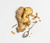 Partially peeled ginger with a spoon
