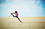 A girl jumping on the beach