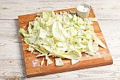 Sliced Chinese cabbage with salt on a chopping board