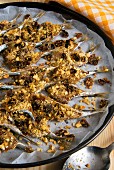 Oven-baked anchovies with ground almonds, raisins, breadcrumbs, wild fennel seeds, olive oil and pepper, Sicily, Italy, Europe