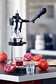 Freshly pressed pomegranate juiced being made with a manual juicer
