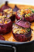 Red onions filled with couscous, dried apricots and herbs