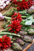 An arrangement of chilli pepper bouquets, artichokes and garlic