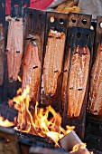 Salmon being smoked over an open fire, Finland
