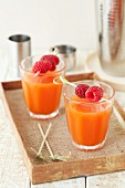 Cocktails made from rum, raspberries, passion fruits and coconut garnished with fresh raspberries