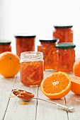 Jars of marmalade and fresh oranges