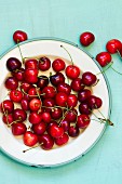 Fresh red cherries on a plate (seen from above)