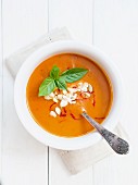 Tomato and pumpkin soup with saffron in a white bowl