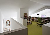 Workspace with half-height shelving and green floor on gallery
