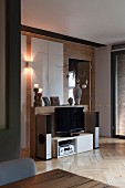 Hi-fi system and flatscreen TV in and on low sideboard in elegant interior