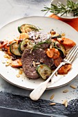 Fillet steak on a carrot courgette medley with raisins