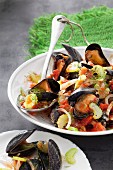 Mussels in a white wine broth with celery and tomatoes