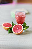A grapefruit smoothie with strawberries and fresh mint